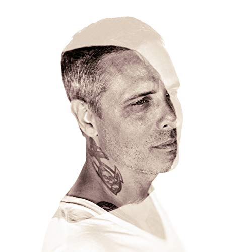 Black and white portrait of a man with part of his face obscured.