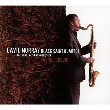 "Album cover: man in suit playing saxophone beside a tree trunk."