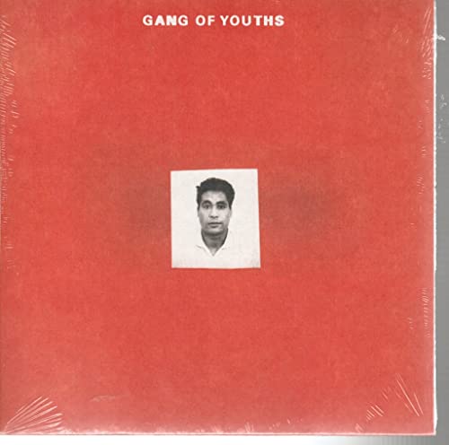 Red album cover with a white framed portrait of a man.
