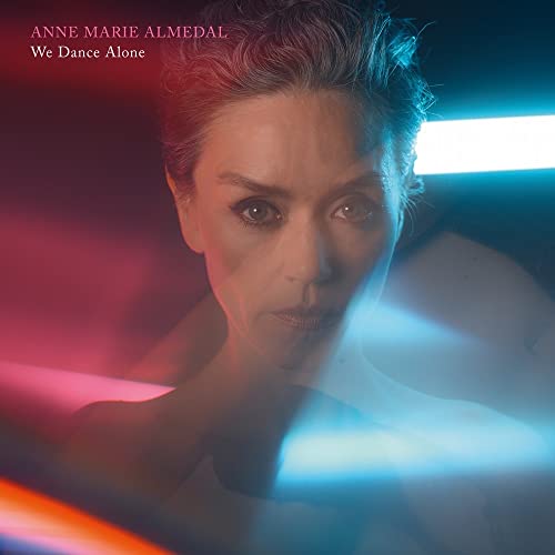 Close-up portrait of Anne Marie Almedal with red and blue lighting.