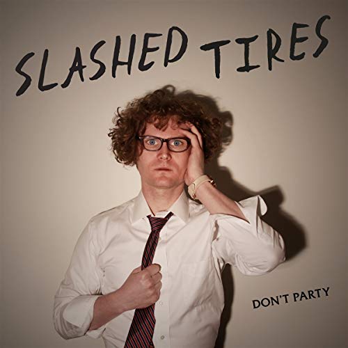 Album cover featuring a man with curly hair and glasses looking distressed.
