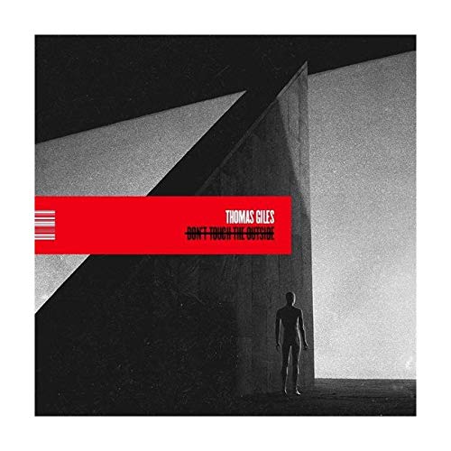 "Album cover featuring a person standing in a dark, abstract, geometric space."