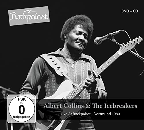 Black and white photo of Albert Collins playing a guitar onstage.