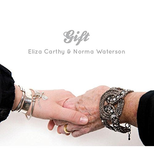 "CD cover with two hands holding, adorned with bracelets, against a white background."