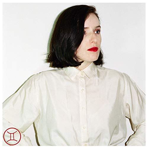 Portrait of a woman with dark hair wearing a white button-down shirt.