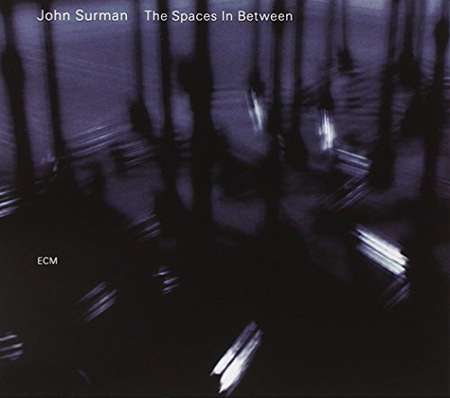 "Album cover with dark, abstract image and white text: 'John Surman - The Spaces In Between'."
