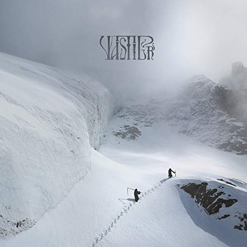 Snowy mountain landscape with two figures walking in the distance.