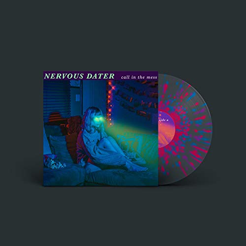 Vinyl record with album cover depicting a person sitting in a dimly lit room.