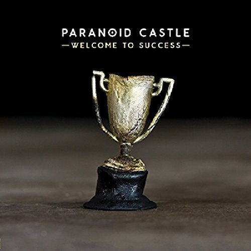 CD cover: gold trophy on a dark, textured surface.