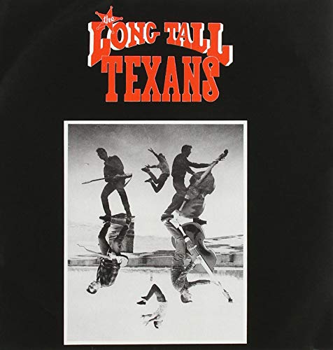 Vinyl record cover: band performing acrobatically with instruments, black and white.