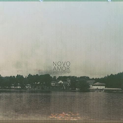 Album cover for Novo Amor’s “Woodgate” featuring a lakeside landscape.