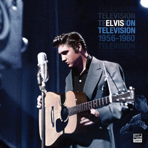 Young Elvis Presley singing into a microphone while playing guitar.