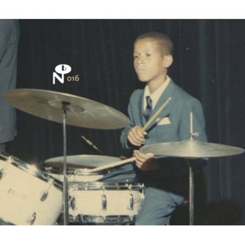 Young boy in suit playing drums, vintage album cover art.