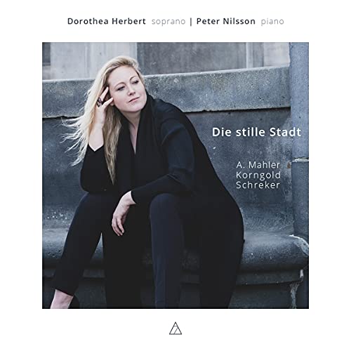 CD cover: blonde woman in black clothing seated on stone steps.