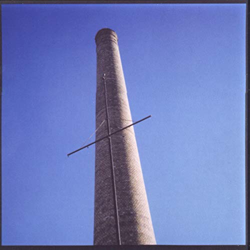 CD cover with a tall brick smokestack against a blue sky.