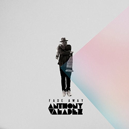"Album cover: man in fedora and dark clothes holding a blanket, pastel background."