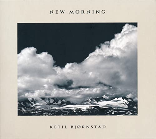 Album cover: snowy mountains under dramatic, cloudy sky.