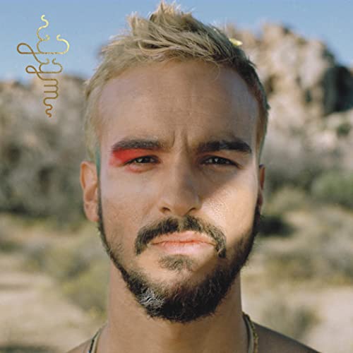 Close-up portrait of Gabriel Garzon Montano with red eyebrow, desert background.