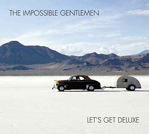 CD cover: black car towing a trailer in a desert landscape.