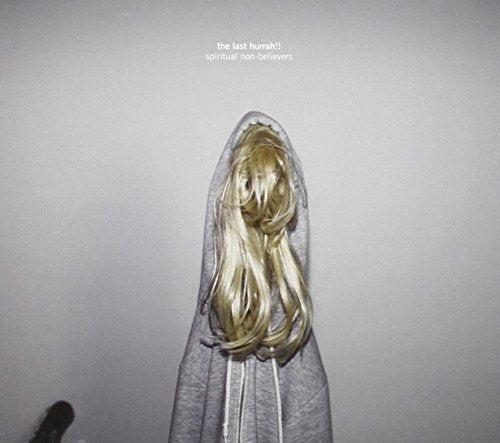 CD cover: person with blonde hair enveloped in a gray hoodie.