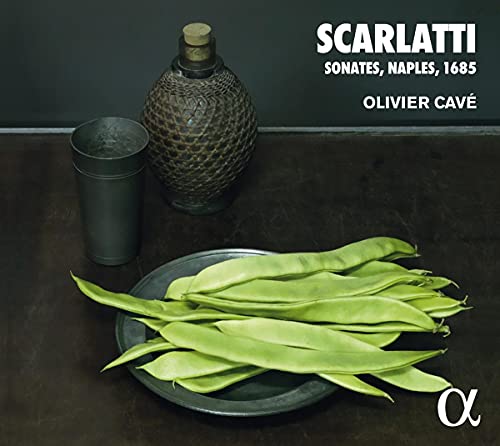 CD cover with antique bottle, beans, and plate on dark background.