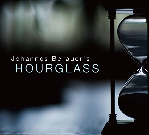 Hourglass with flowing sand, dark background, and album title text.