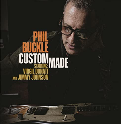 CD cover featuring Phil Buckle with a guitar, dark background.