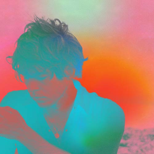 The alt text for the image is: "Vinyl album cover with a man in front of a colorful background."