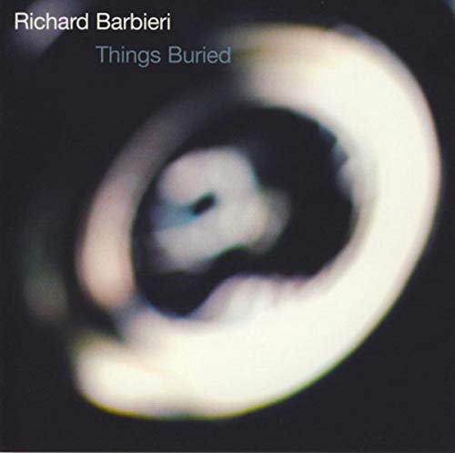 Vinyl album cover with blurred white spiral on black background, artist and title visible.