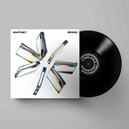 Whitney’s “SPARK” vinyl record with a geometric, fractured crystal design.