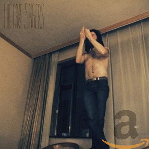 CD cover: shirtless man with hands up, beige and brown tones.