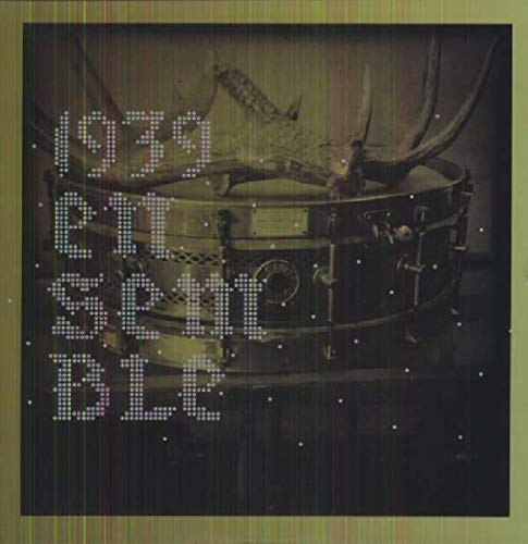 A sepia-toned album cover featuring a snare drum with antlers on top.