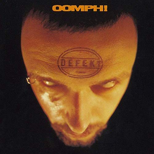 "Album cover featuring a man's face with a 'defekt' stamp on his forehead."