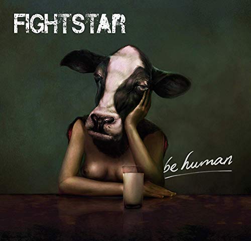 Album cover: woman with a cow’s head, glass of milk, dark background.