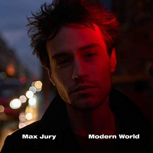 "Man with messy brown hair and stubble, lit by red light, city lights blurred behind."