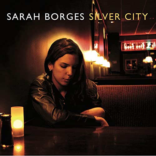 Sarah Borges album cover, featuring a woman in a dark bar setting.
