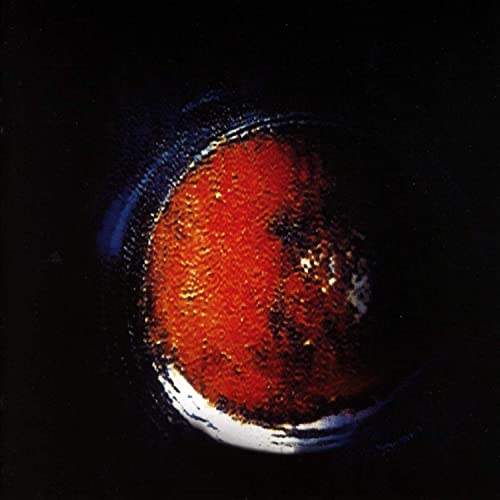Dark album cover featuring a textured, fiery orange and blue planet.