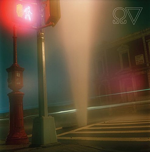 The alt text for the image is: "Red traffic light with pedestrian signal at a city intersection."