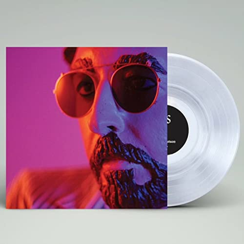 Vinyl record with album cover featuring a close-up of a man in sunglasses.