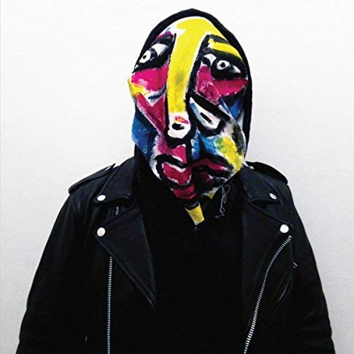 Person wearing a colorful, painted mask and black leather jacket.