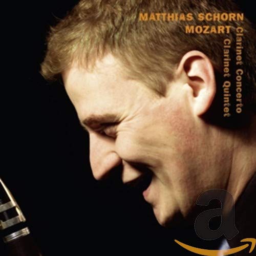"CD cover featuring a man holding a clarinet with orange text on a black background."