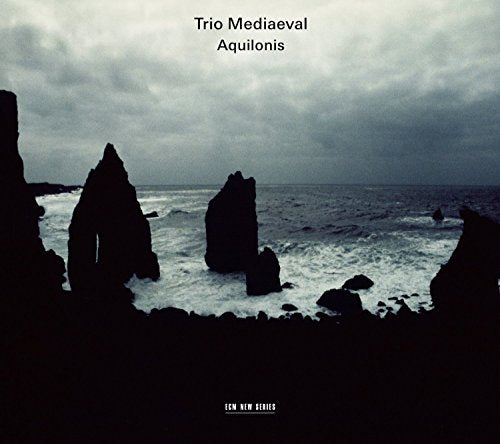 "Album cover featuring a dark, stormy seascape with rocky silhouettes and cloudy sky."