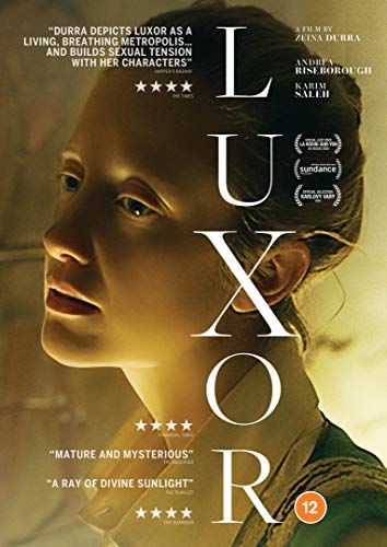 DVD cover for “Luxor” featuring a woman’s face in warm light.