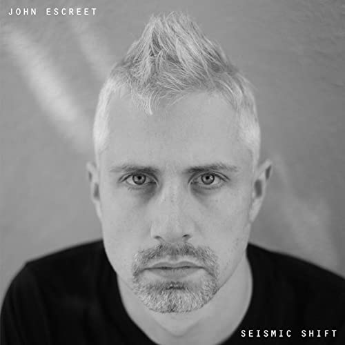Black and white portrait of John Escreet, album "Seismic Shift" cover.