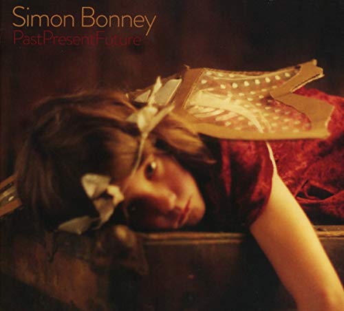 CD cover: woman with paper sculpture, reddish tones, Simon Bonney album.