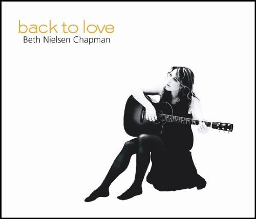 "Album cover with a black-and-white image of a woman playing an acoustic guitar."