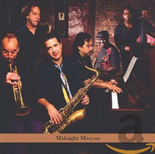 "CD cover featuring a group of musicians playing various instruments together."