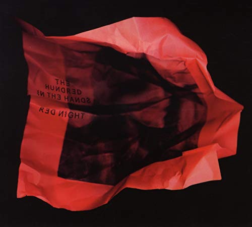 Red and black abstract album cover with crumpled plastic texture.
