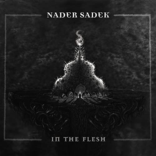Dark album cover for Nader Sadek’s “In The Flesh” with a thorny, gothic spire.