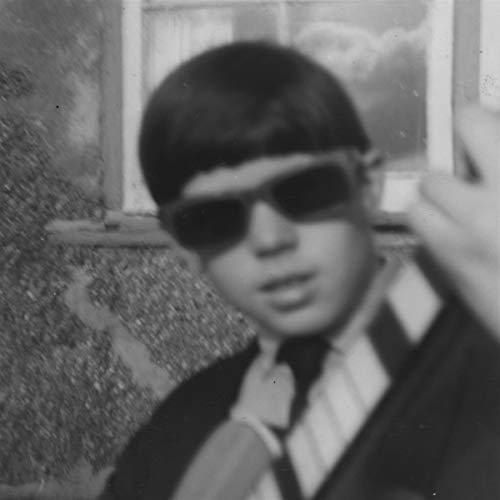 Black and white portrait of a young man wearing sunglasses.